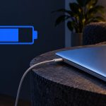 Laptop connected to a charger beside a half-filled battery symbol.
